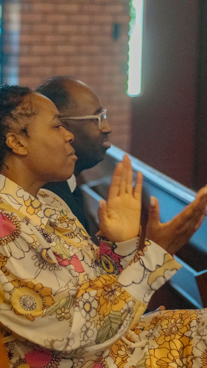 A couple clapping in the pews