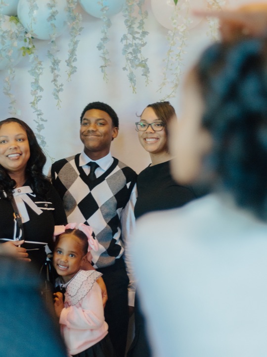 A Greater Faith family smiling together at a church celebration