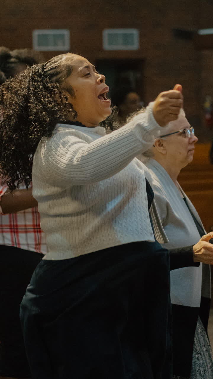 A woman singing in the pews