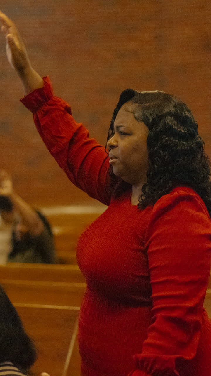 A woman in red praising